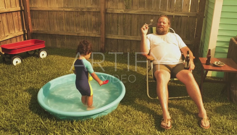 Man Relaxing Smoking In Backyard & Son in Kitty Pool